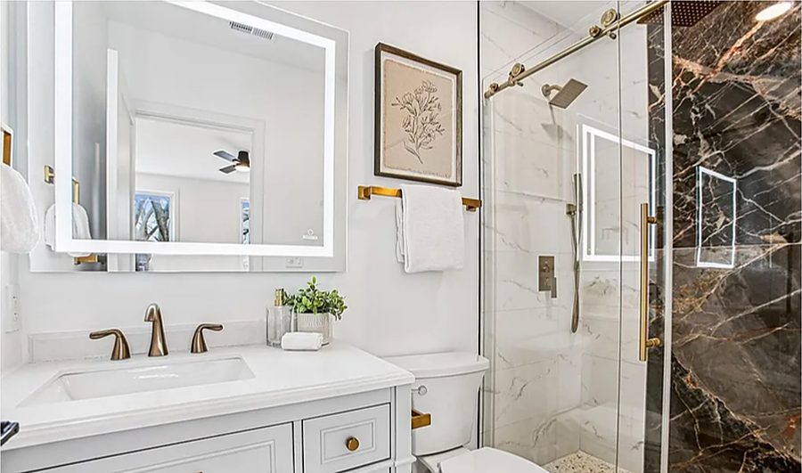 Warm Marble & Brass Bath — Bathrooms by DFC Home Improvement
