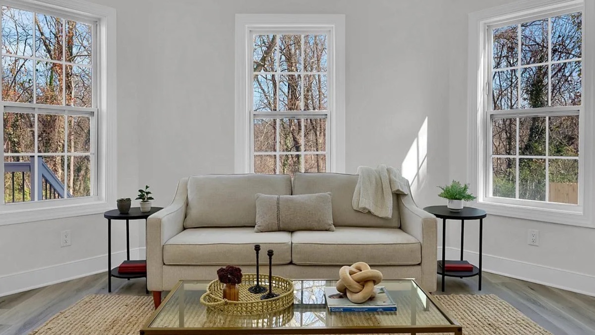 Sunlit living room with large windows by DFC Home Improvement